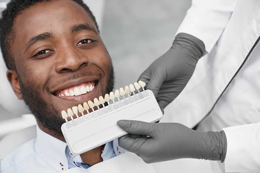 Male patient smiling after receiving white fillings in Las Vegas. 